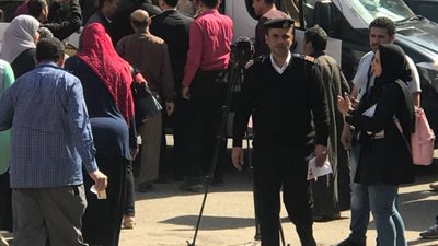 قوات الشرطة تنقل مسنة بعد الإدلاء بصوتها في الانتخابات الرئاسية 2018