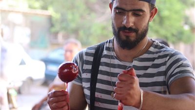 صور| بائع حلوى التفاح.. تجربة رائعة وطعم أجمل